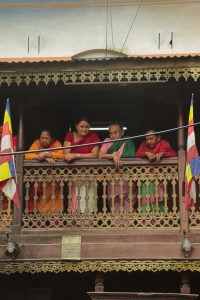4 nepali women standing on balcony